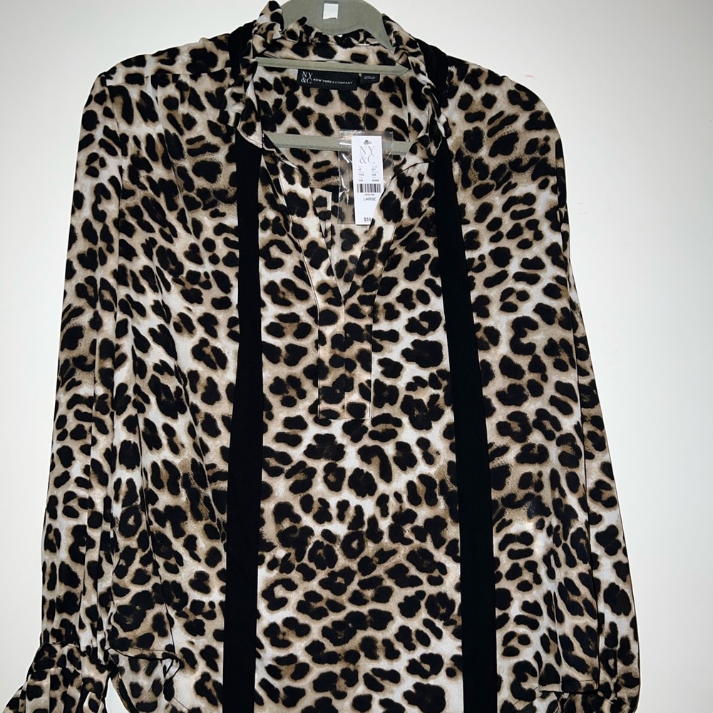 NY&C blouse Cheetah print long sleeve new large. 100% polyester material.
